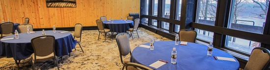 A conference room set in rounds with floor to ceiling windows overlooking the state park.